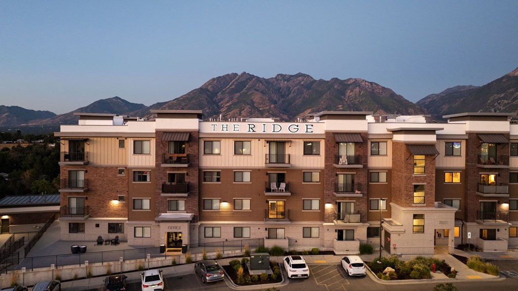 a large hotel with mountains in the background