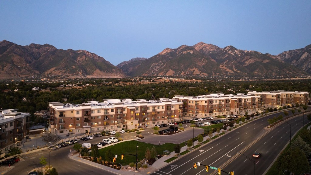 an aerial view of a city with mountains in the background