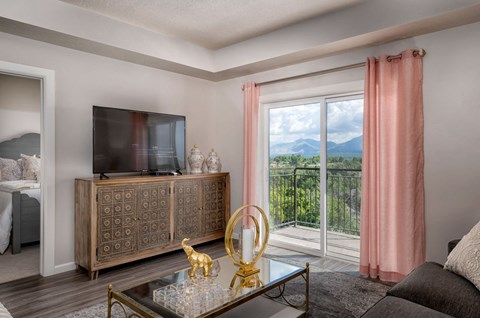 a living room with a large window and a television