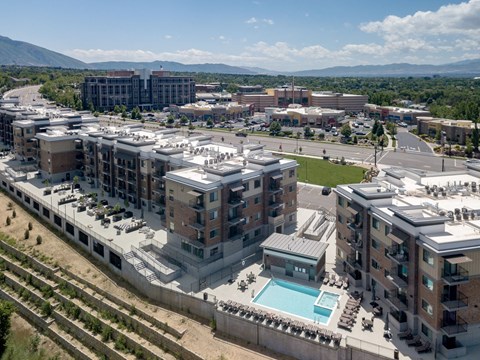 an aerial view of a city with buildings and a pool