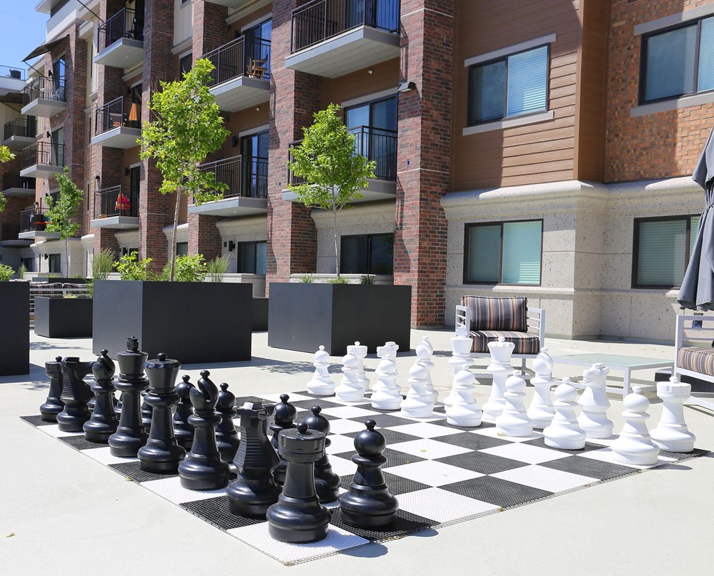 a giant chess board in front of an apartment building