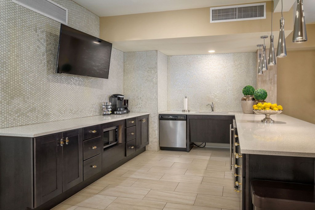 a kitchen with stainless steel appliances and a large counter top