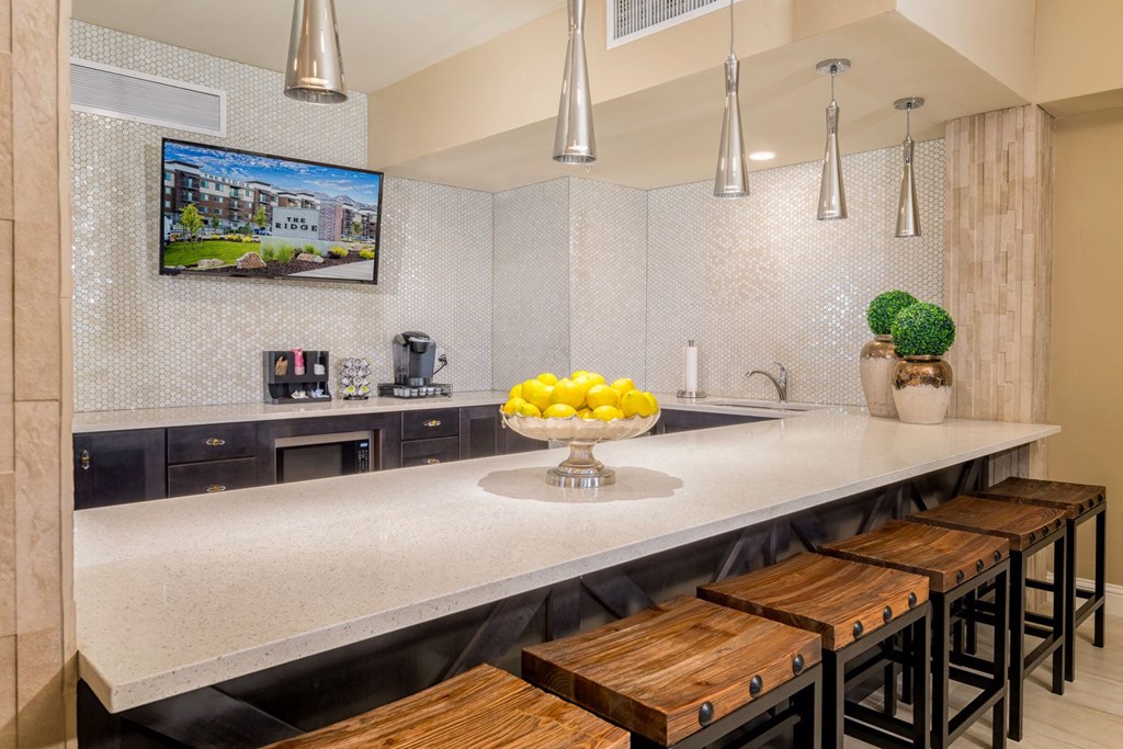 a kitchen with a long counter and a bowl of fruit