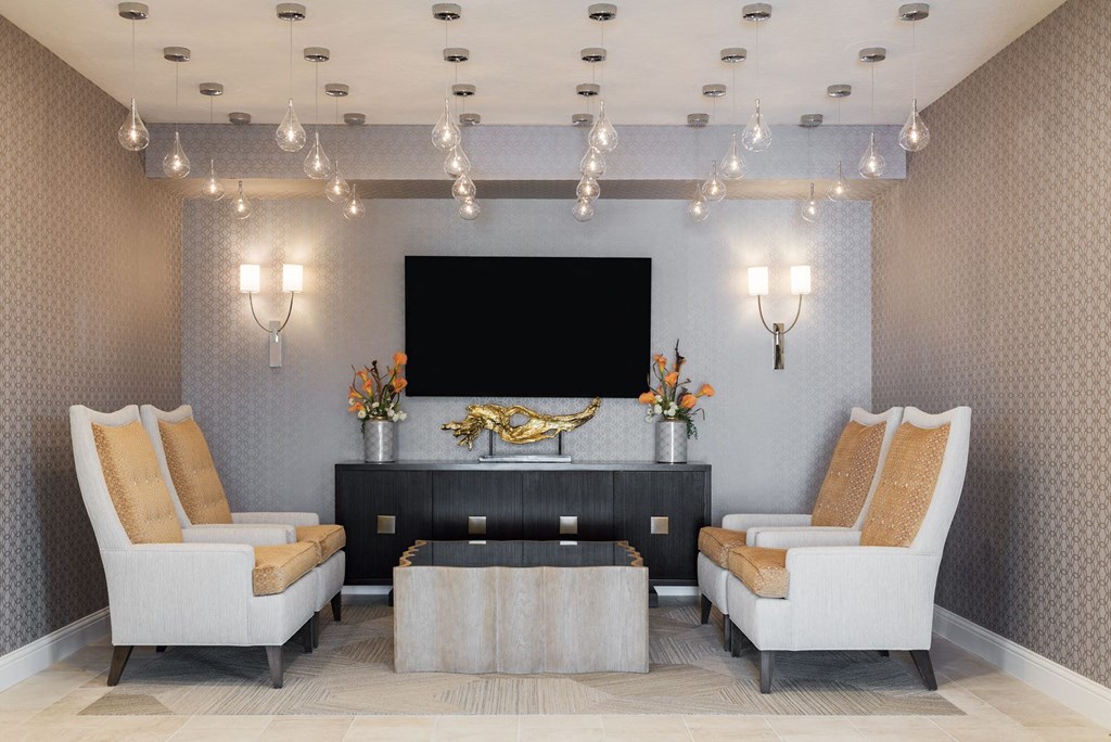 a lobby with chairs and a television