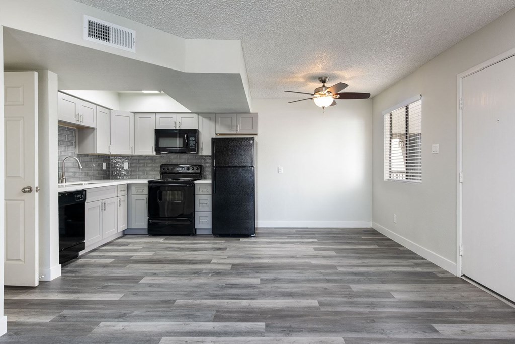 A kitchen with a black oven and microwave.