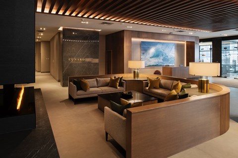 A modern living room with a fireplace and a large painting on the wall.