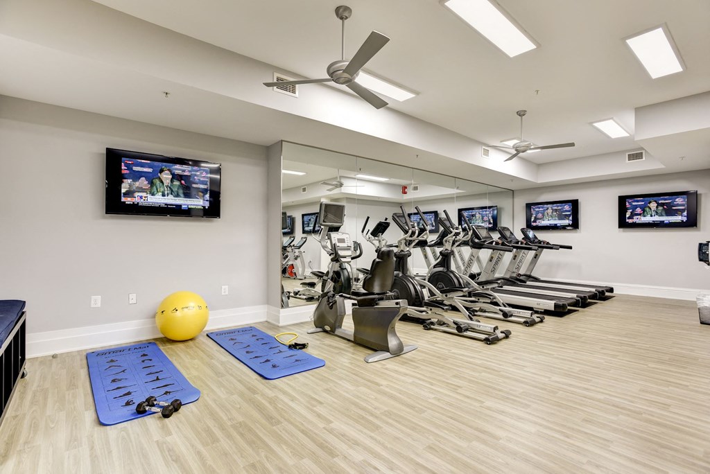 our state of the art gym is full of cardio equipment and televisions