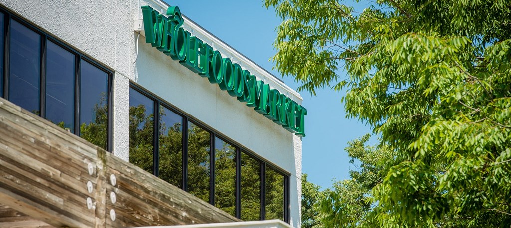 the side of a building with windows and trees at The Metropolitan Downtown Columbia, Columbia, Maryland