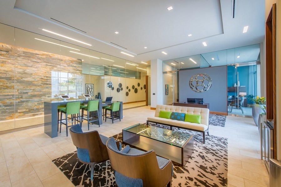 a living room and dining room with a table and chairs at The Metropolitan Downtown Columbia, Columbia, MD