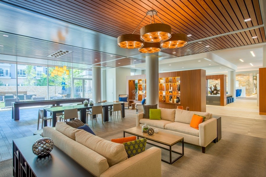 a living room with couches and a table in a lobby at The Metropolitan Downtown Columbia, Columbia, Maryland