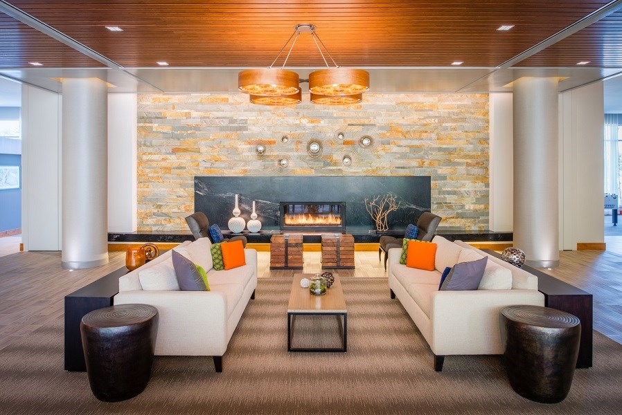 a living room with couches and a fireplace at The Metropolitan Downtown Columbia, Maryland, 21044
