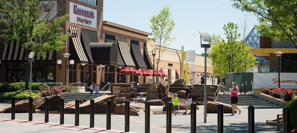 a city street with an exhibit of rocks in front of a building at The Metropolitan Downtown Columbia, Maryland