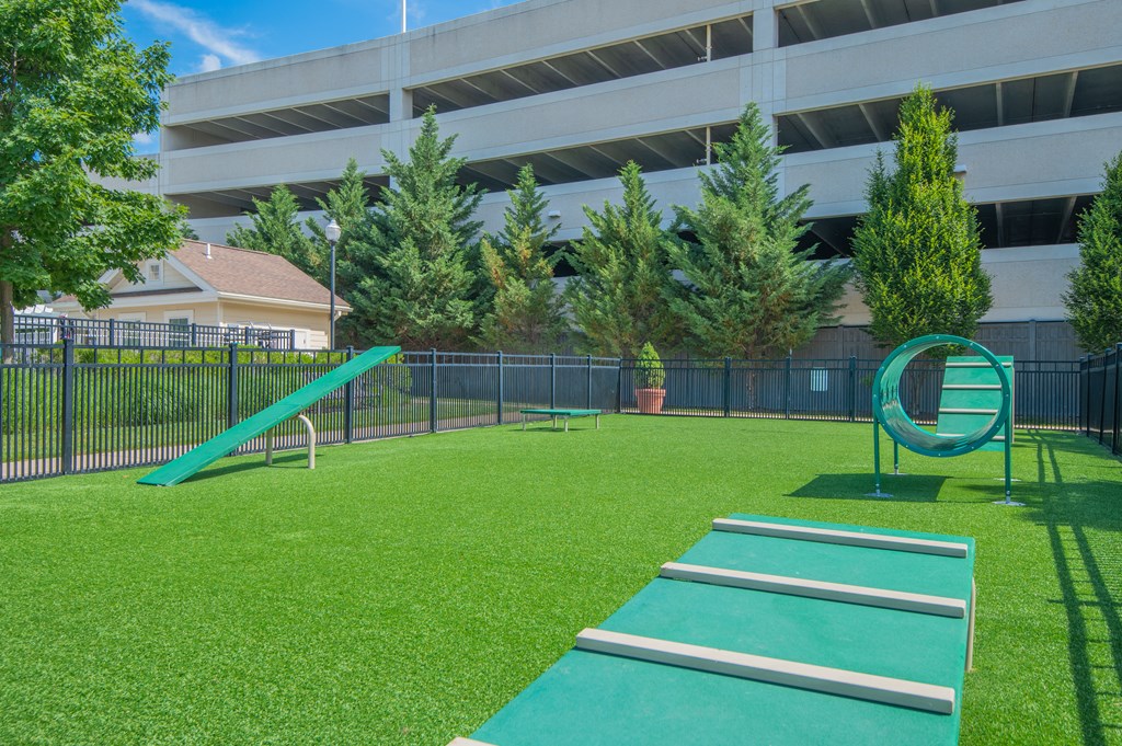 a playground with a slide and a swing set in front of an office building