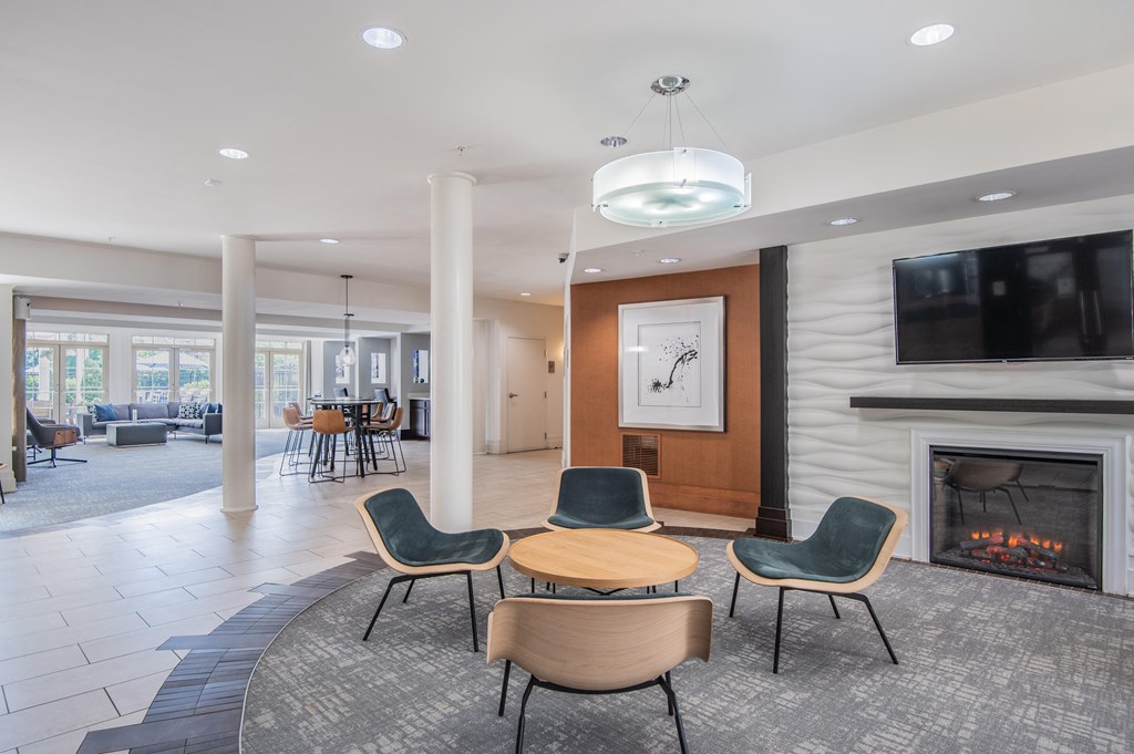 a living room with a fireplace and a table and chairs