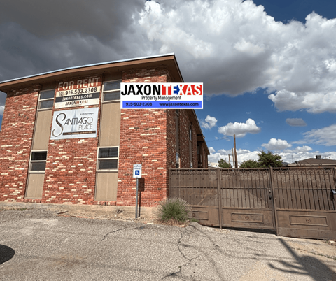 A building with a sign that says "Jaxon Property Management" in front of it.