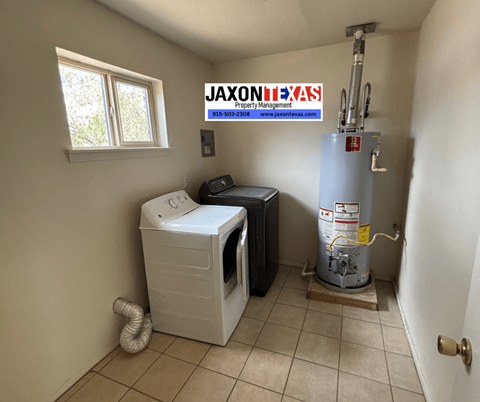 A small room with a washer and dryer and a water heater.