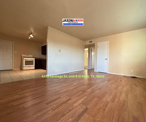 Empty room with wooden flooring and a JAXON REDS sign on the wall.