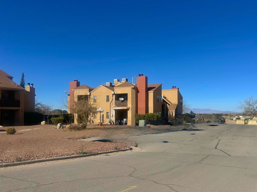 A large building with a parking lot in front of it.