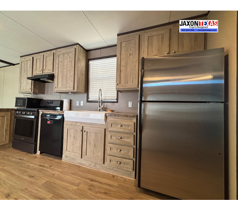 A kitchen with wooden cabinets and a stainless steel refrigerator.