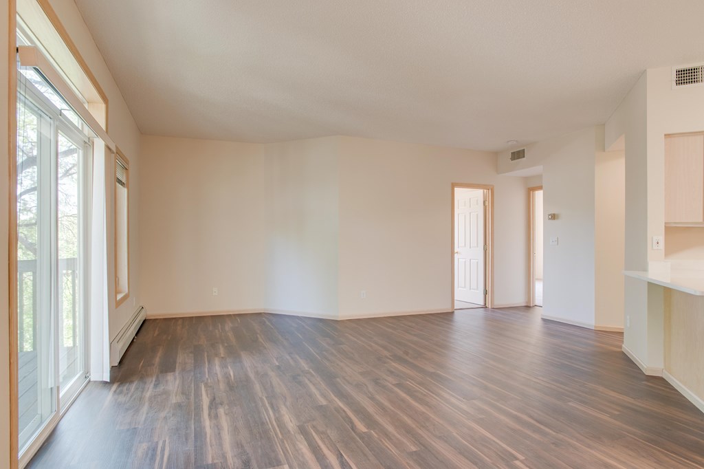 A room with wooden floors and white walls. at Eighth Street Manor Apartments, Fargo