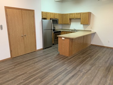 Wood Floor Dining Room at Warehouse Apartments, North Dakota - Photo Gallery 4