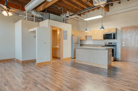 A kitchen area with wooden floors and a counter, Kassenborg Apartments, Moorhead, MN, 56560