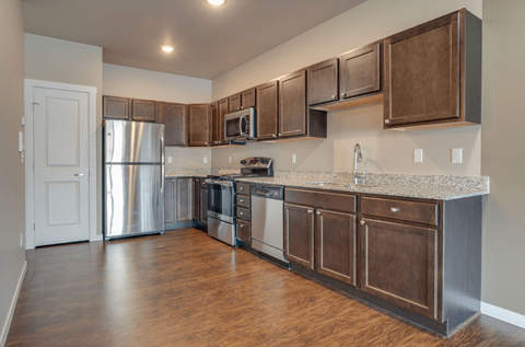 A kitchen with wooden cabinets and stainless steel appliances.