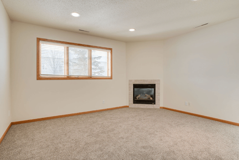 A room with a fireplace and a window.