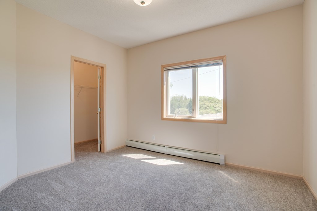 A room with a window and a door. at Eighth Street Manor Apartments, Fargo, North Dakota