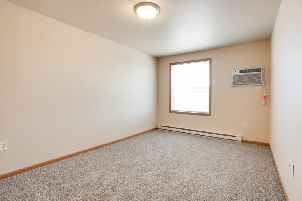 the living room of an empty house with a window