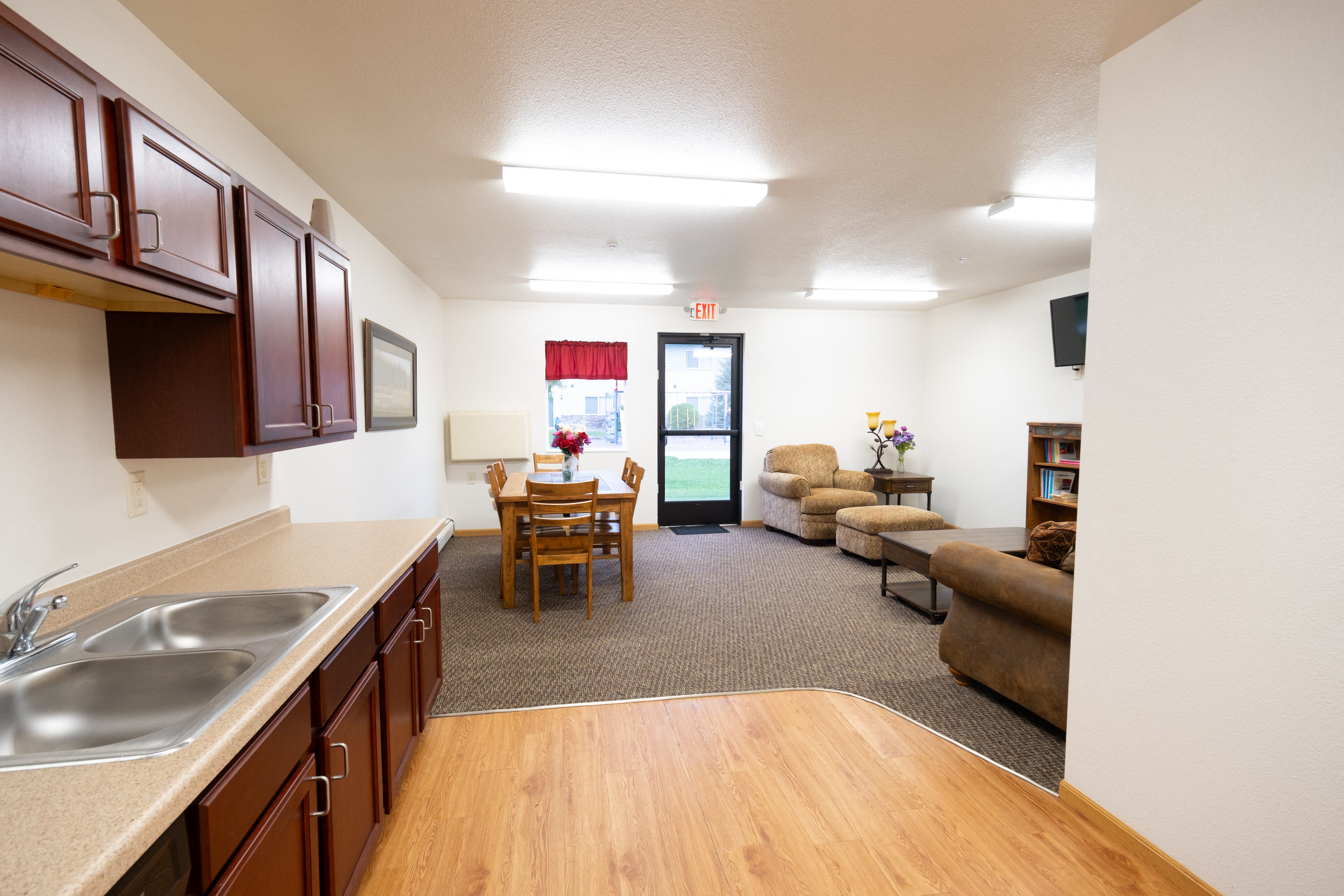 a living room with a kitchen and a dining room