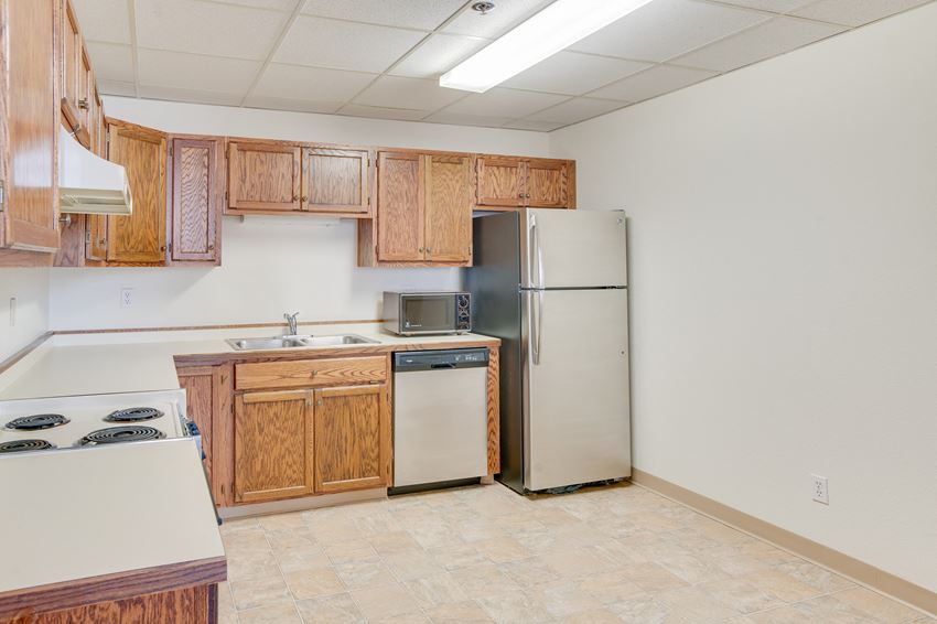 a kitchen with wooden cabinets and stainless steel appliances