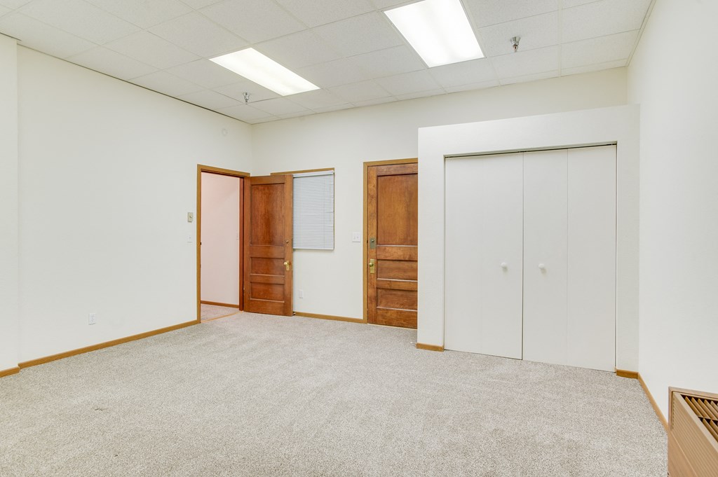 a room with two doors and a carpeted floor