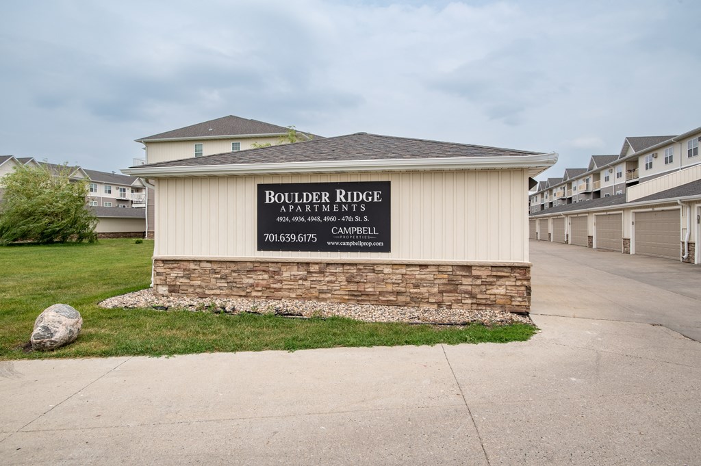 a building with a sign that says boulder river apartments at Boulder Ridge Apartments, North Dakota