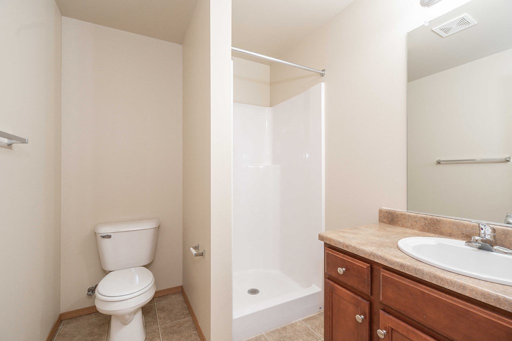 a bathroom with a toilet and a sink and a shower