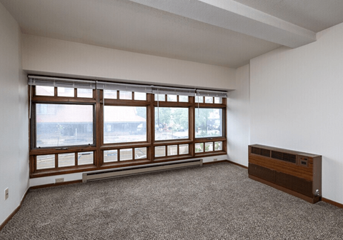 A room with a large window and a radiator on the wall at Block 6 Apartments, Fargo, ND, 58103