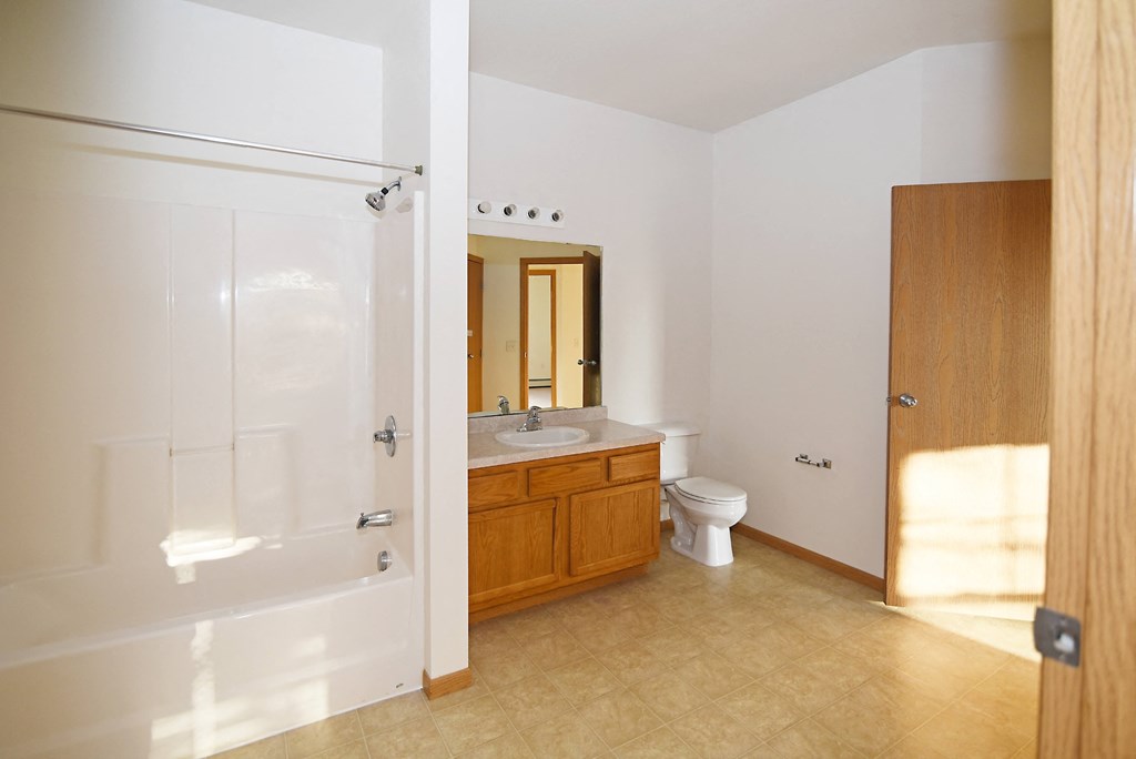 a bathroom with a toilet and a sink and a shower