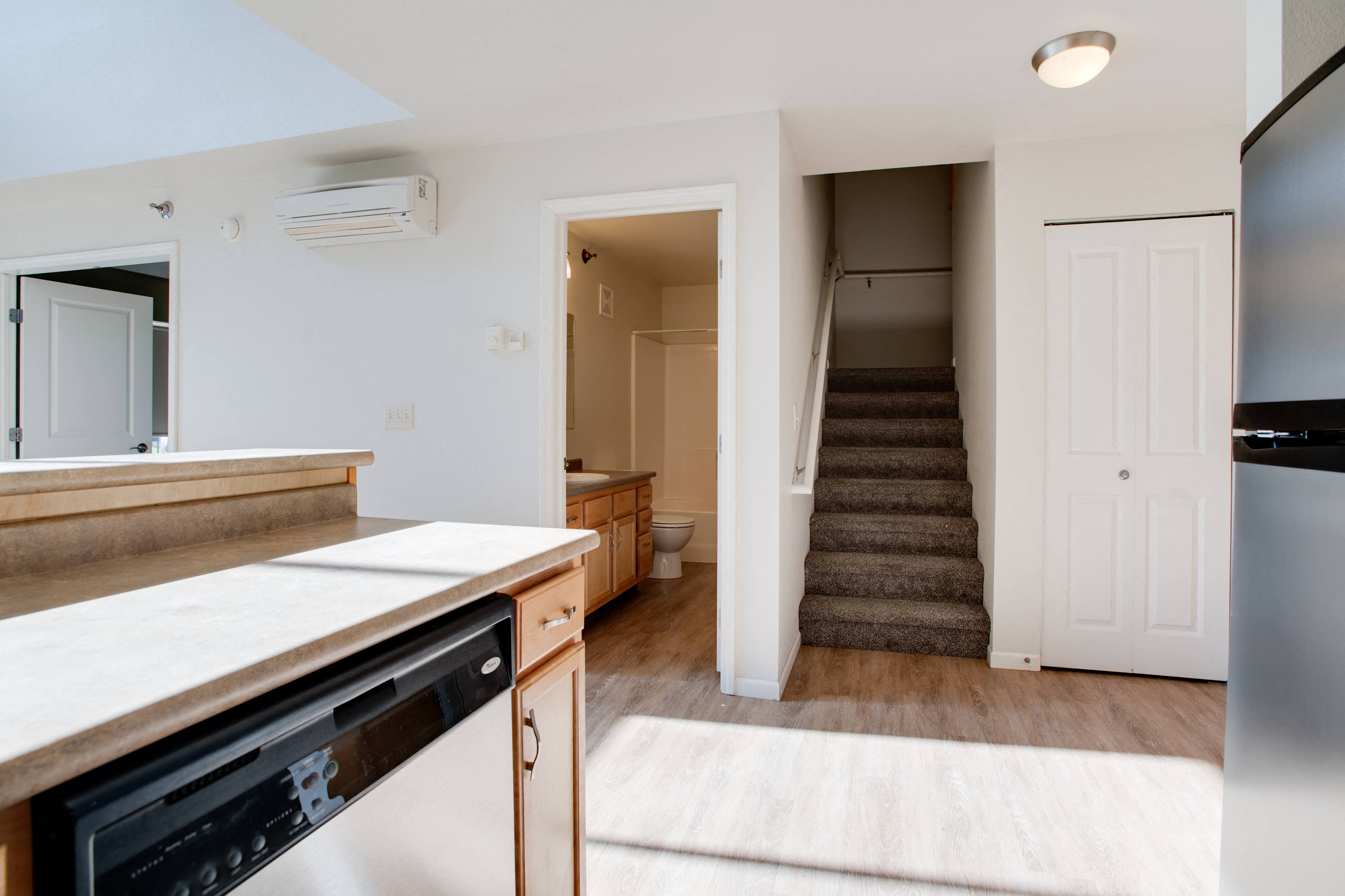 a kitchen with a sink and a stove and a staircase in a home with stairs