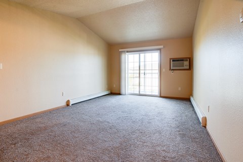 an empty living room with a window and carpet at Waterstone Apartments, Moorhead, Minnesota