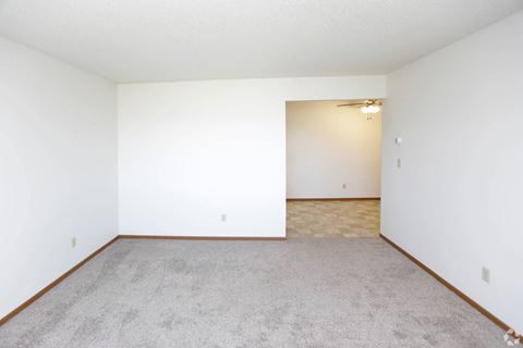 an empty room with a carpeted floor