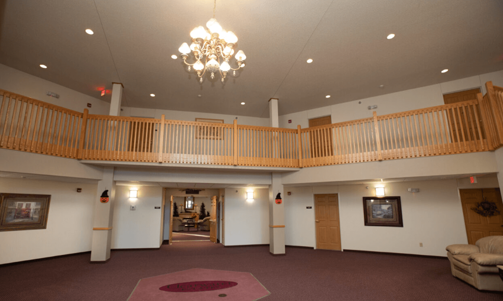 a large room with a balcony and a chandelier