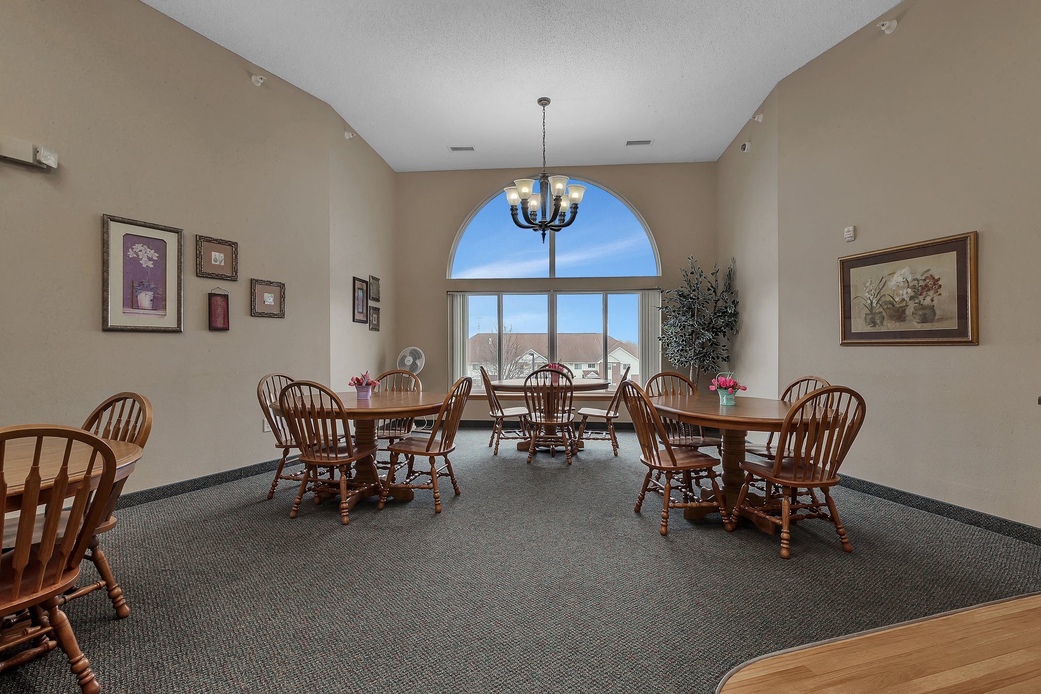 a dining room with a table and chairs and a large window at Savanna Apartments, St Cloud, MN, 56303