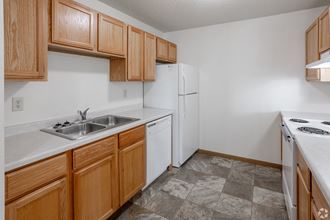 a kitchen with white appliances and wooden cabinets
