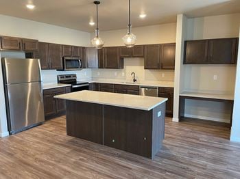 Kitchen With Modern Lighting at Augusta Apartments, Fargo, ND
