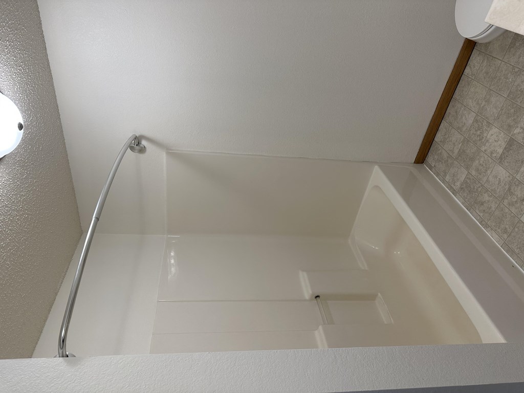 a large white bathtub in a bathroom at Northridge Apartments, Pine City