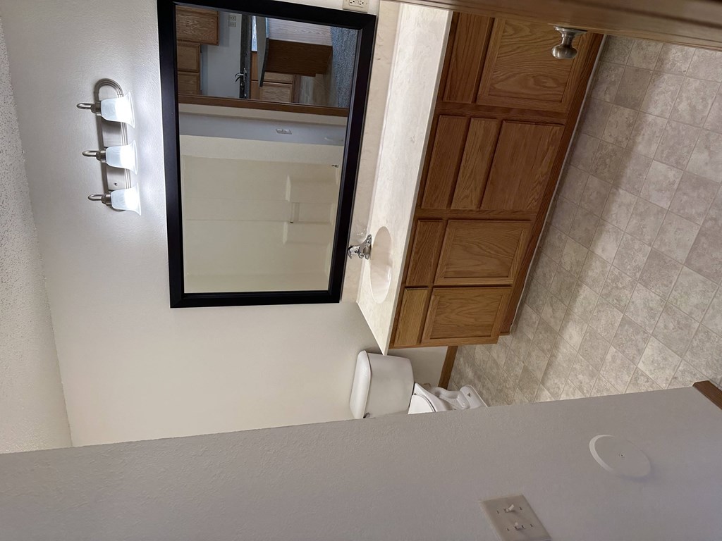 a small bathroom with a toilet and a sink at Northridge Apartments, Minnesota