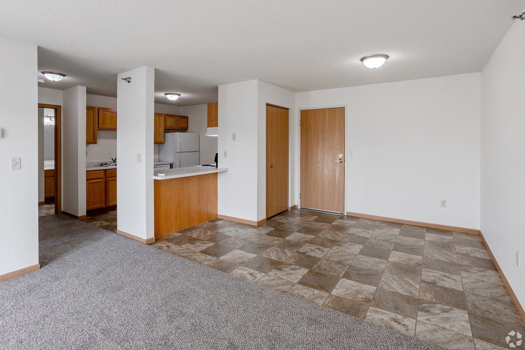 Empty living room and kitchen at Hillcrest Apartments, MN, 56301