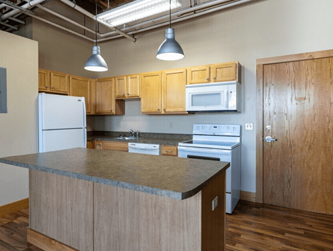 A kitchen with wooden cabinets and a granite countertop.