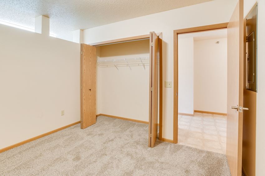 a bedroom with a closet and an open door