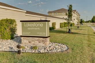 a picture of the lakeside apartments sign with a building in the background